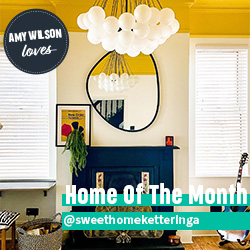 A beautiful set of white taped wooden blinds in a very bright room