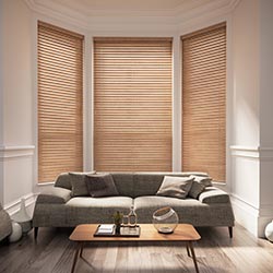 A brown wooden blind in a living room bay window