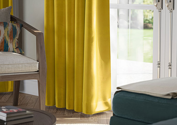 A beautiful set of white taped wooden blinds in a very bright room